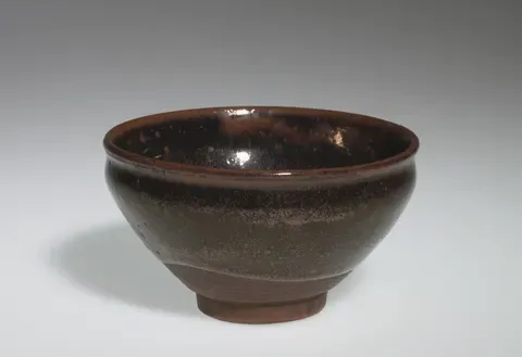A tenmoku tea bowl glazed a lustrous brown-black