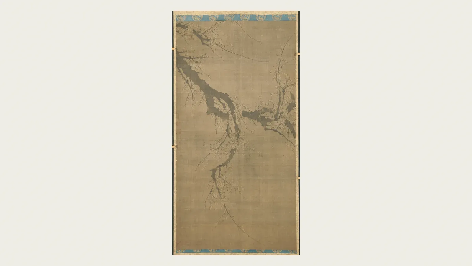 A single plum branch brushed in ink on a tall scroll
