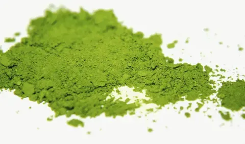 A heap of finely milled matcha, bright green and powdery