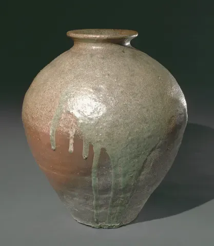 A wood-fired stoneware jar streaked with green ash glaze